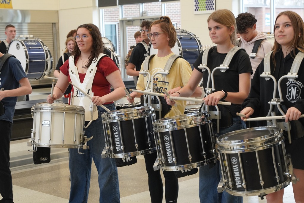 HMS drum line playing in the cafeteria as students walk out of the building for Spring Break
