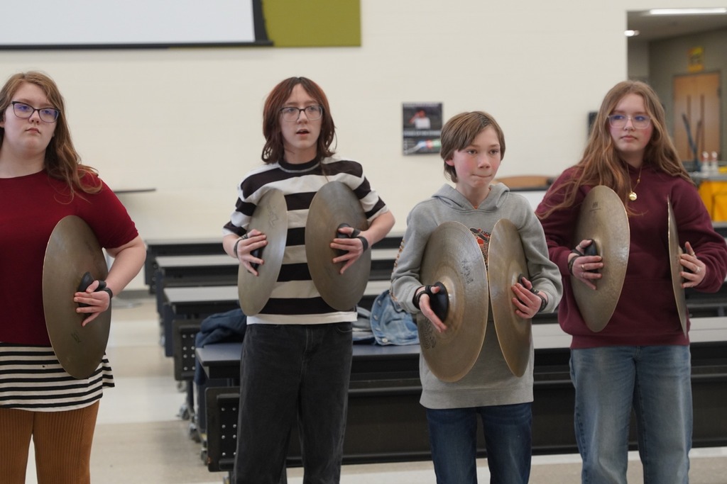HMS drum line playing in the cafeteria as students walk out of the building for Spring Break