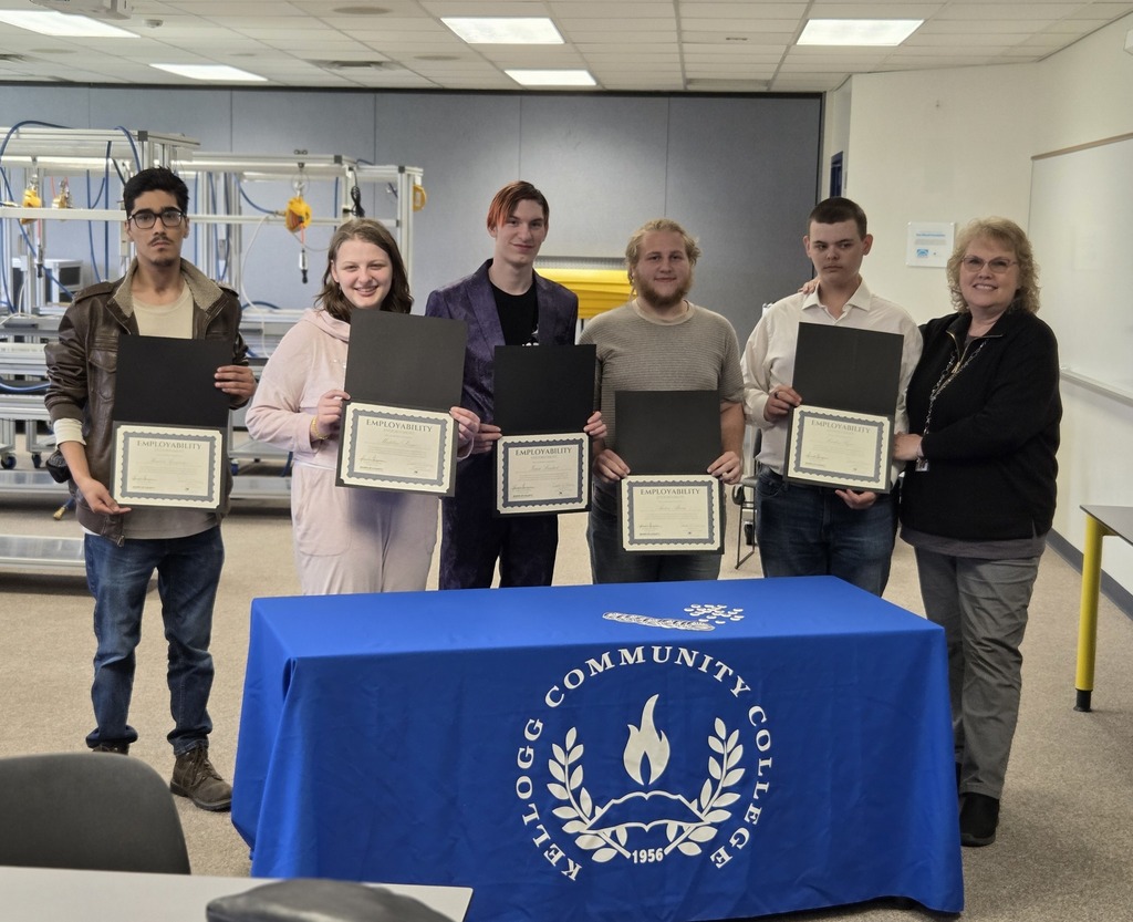 High school seniors accepting their paper certificates and posing for the camera