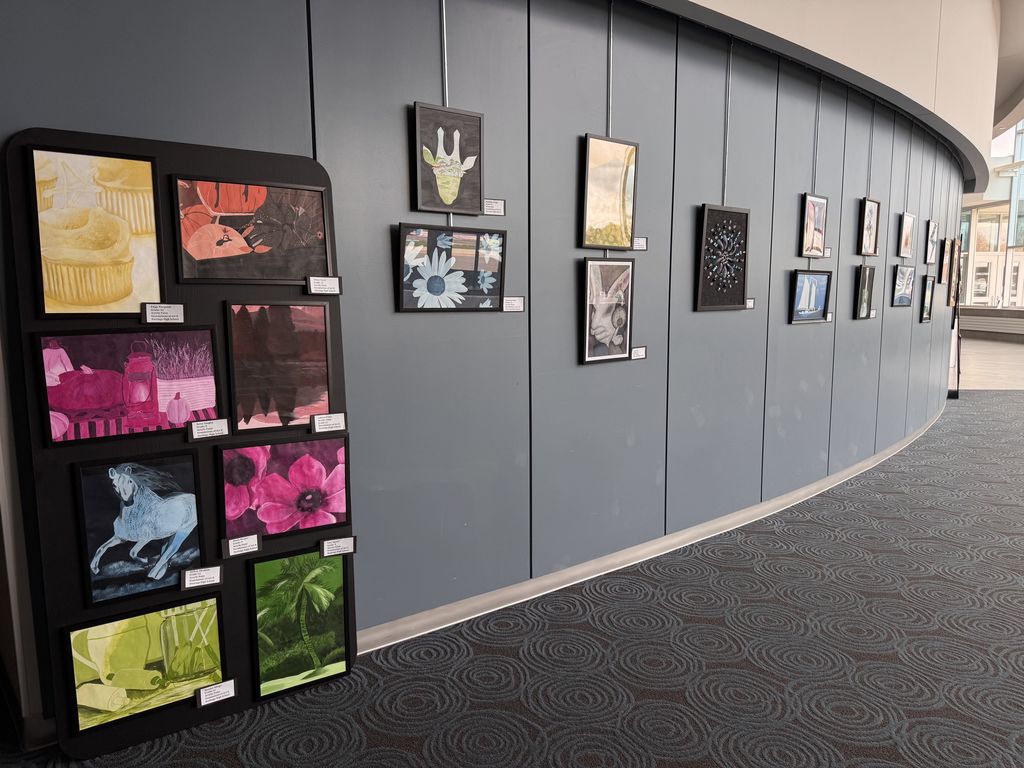 A variety of art work displayed on a wall
