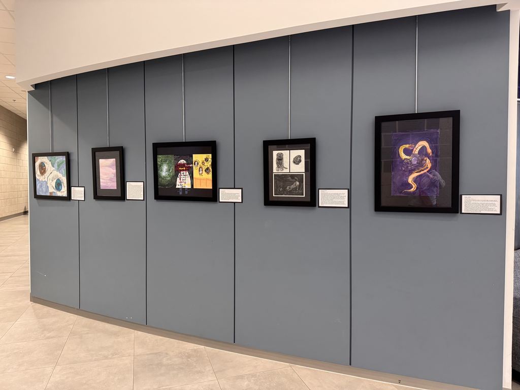 A variety of art work displayed on a wall