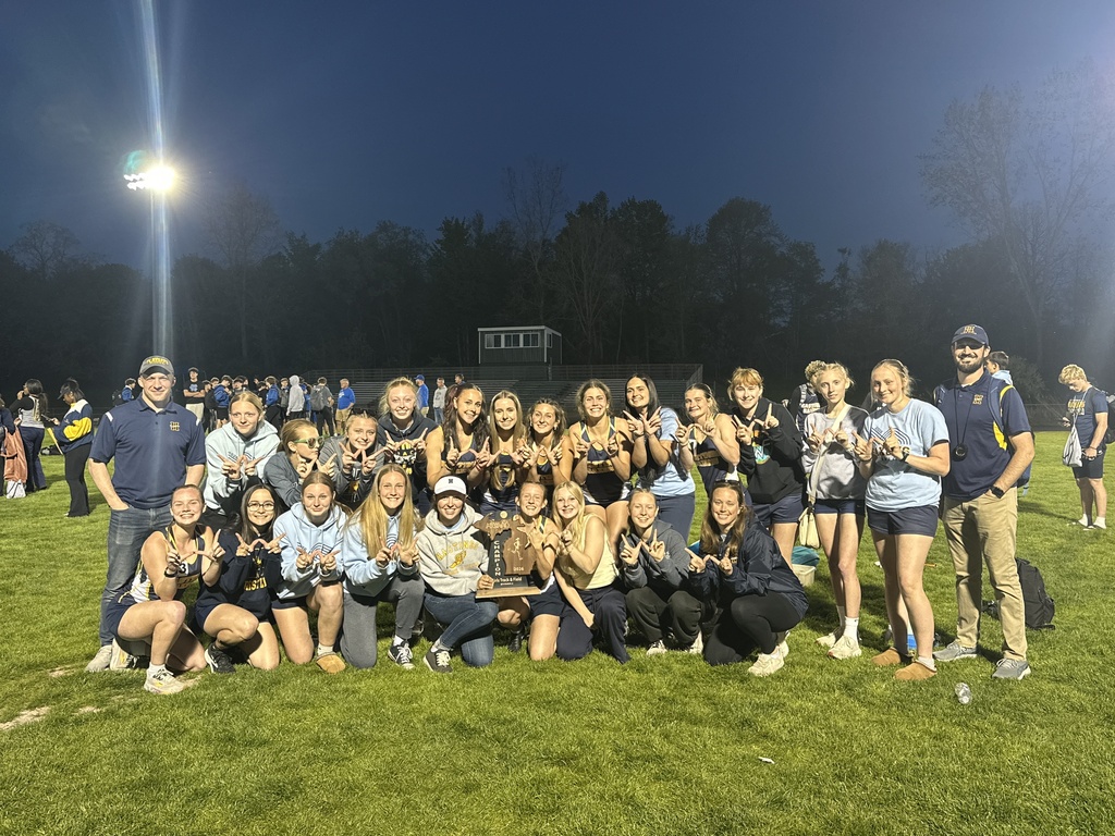 The entire Hastings High School girls track and field team poses for a photo with a trophy