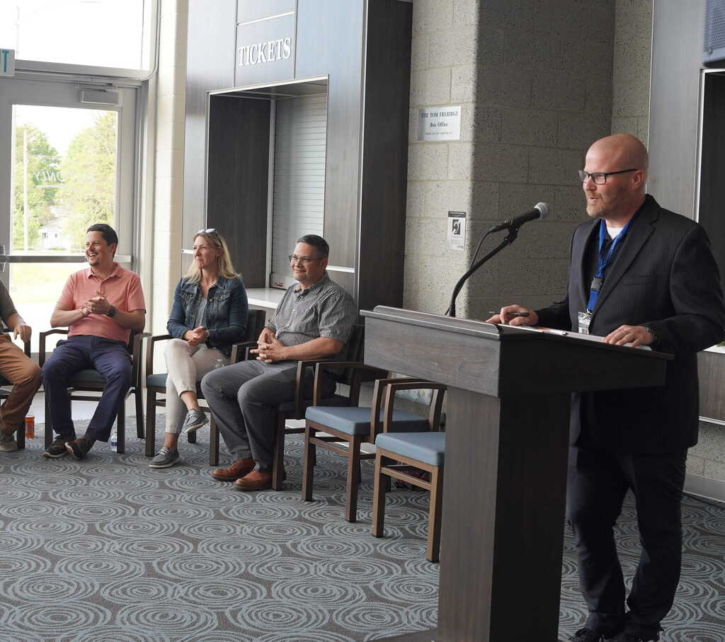 Retiring staff members are honored at a reception with folks speaking from the podium