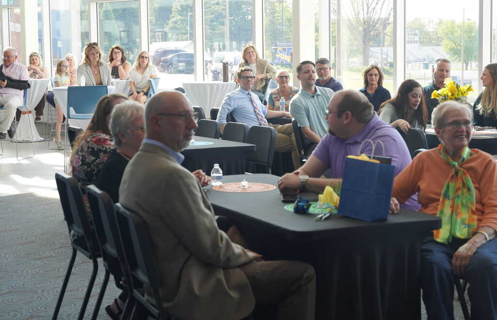 Retiring staff members are honored at a reception with folks speaking from the podium