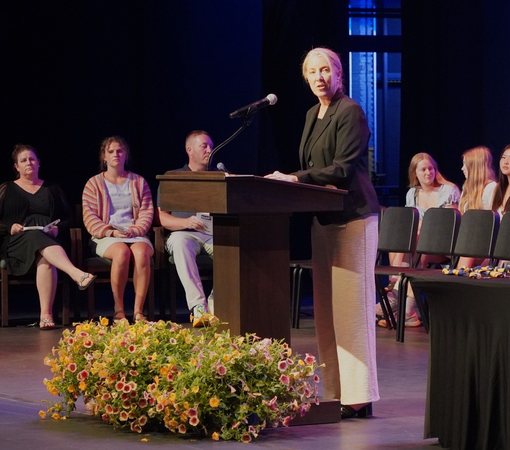 Students seated on stage and speakers present at HHS underclassmen honors night