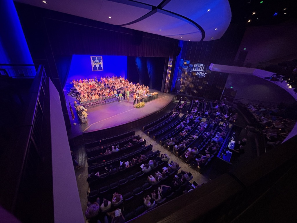 Students seated on stage and speakers present at HHS underclassmen honors night