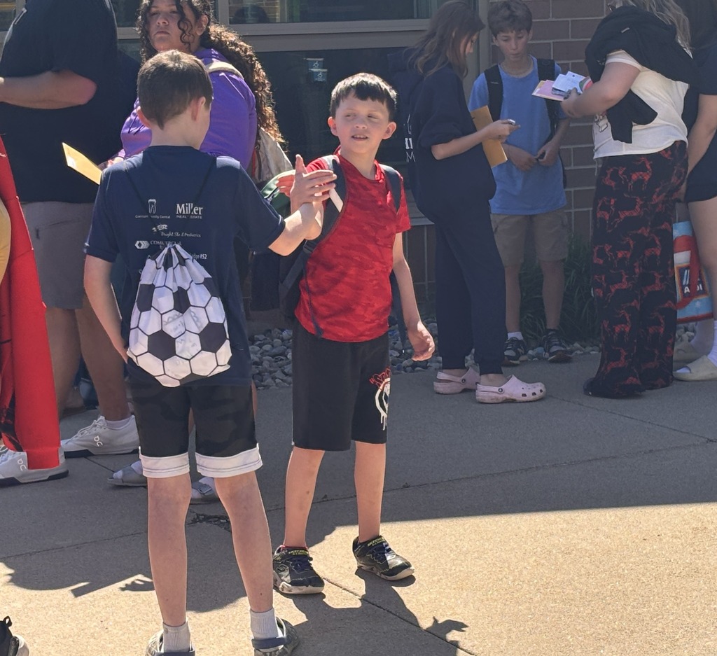 Two boys exchange a high five.