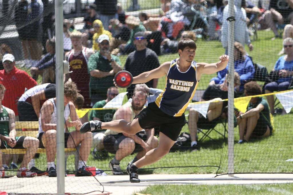 A male athlete winds up ready to launch a discus