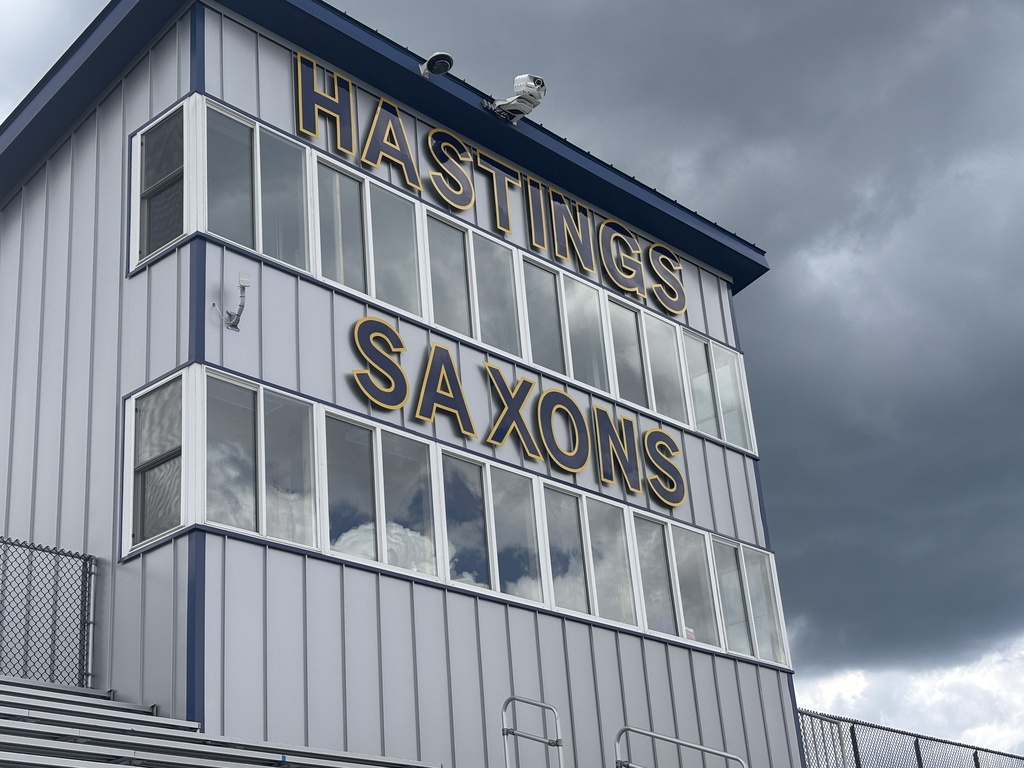 The pressbox of a football field. The tower has lettering on it that says "Hastings Saxons"