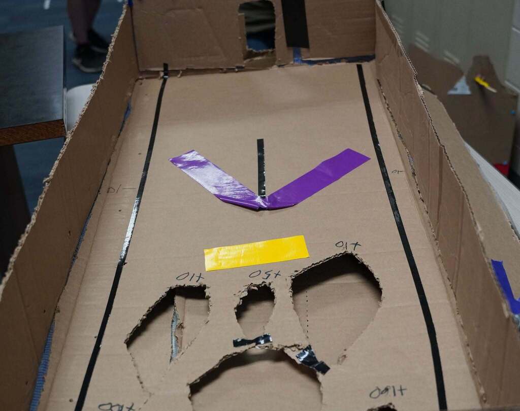 A close up look at a cardboard game created by a student.