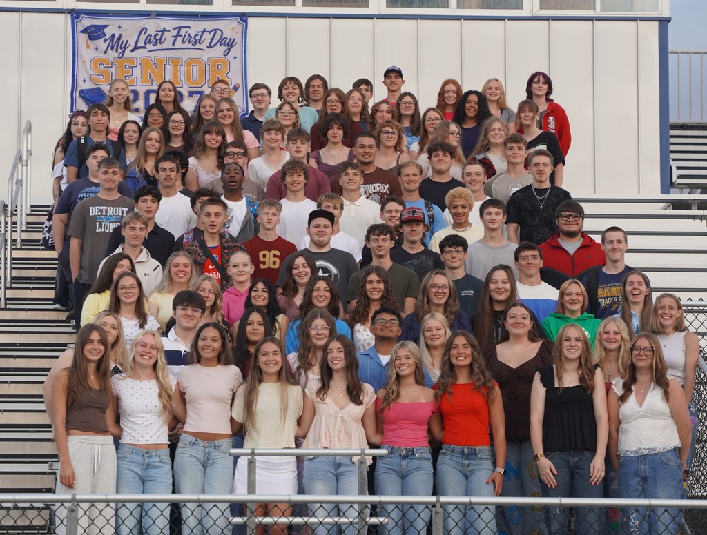 A large group of high school kids gather on the bleachers for a large group shot.