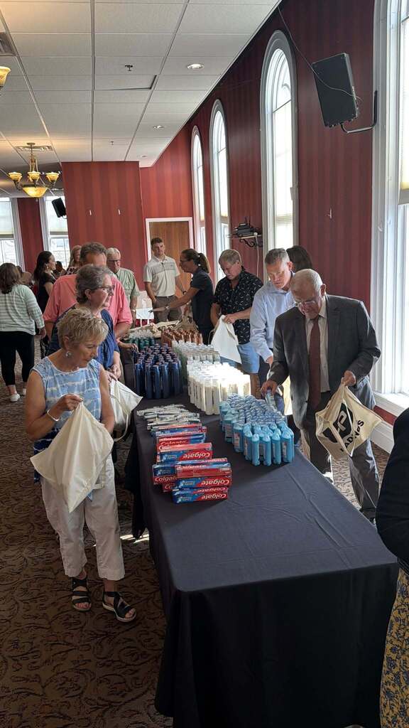 People work to pack up bags of hygeine products