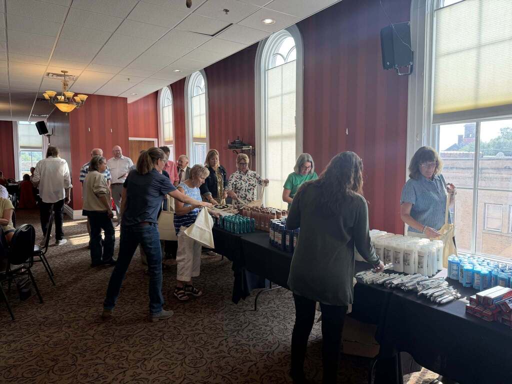 People work to pack up bags of hygeine products
