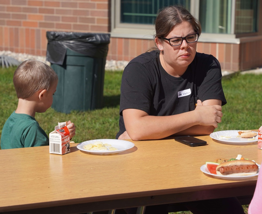 students and parents enjoy a picnic and petting zoo at star elementary school
