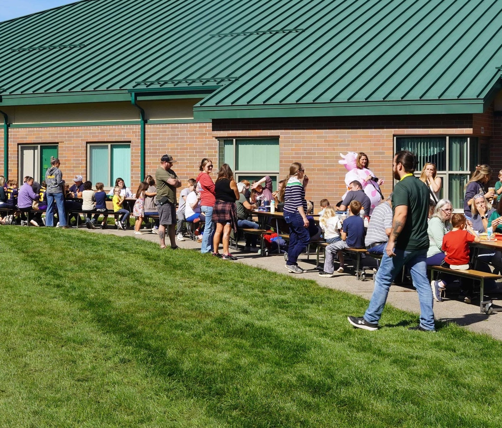 students and parents enjoy a picnic and petting zoo at star elementary school
