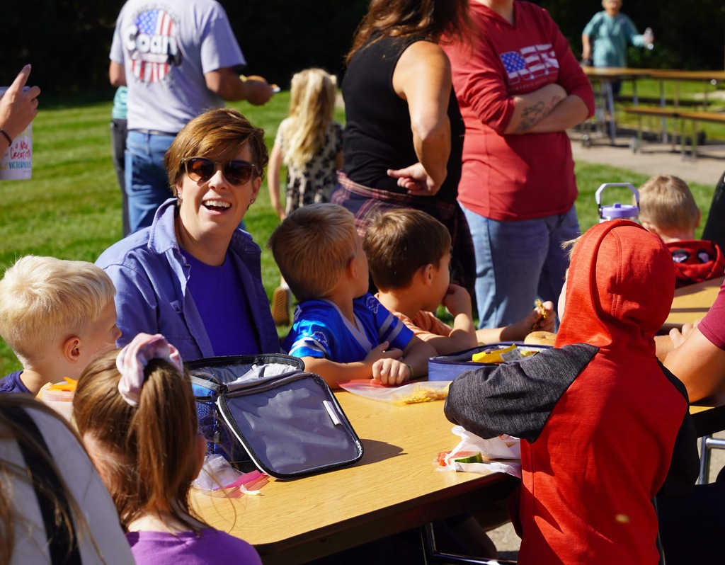 students and parents enjoy a picnic and petting zoo at star elementary school