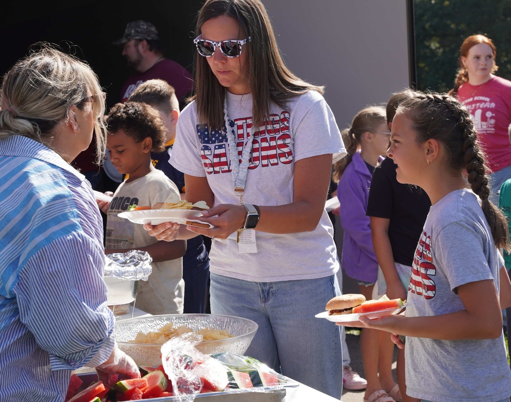 students and parents enjoy a picnic and petting zoo at star elementary school