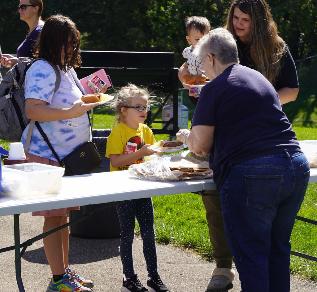 students and parents enjoy a picnic and petting zoo at star elementary school
