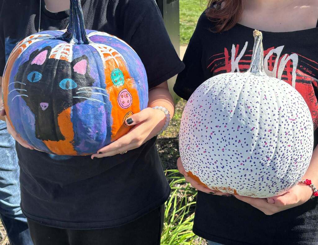 School kids display painted pumpkins