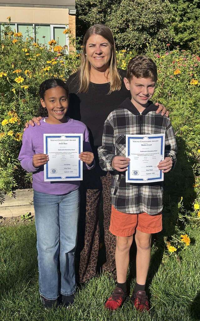 Kids pose while holding a certificate