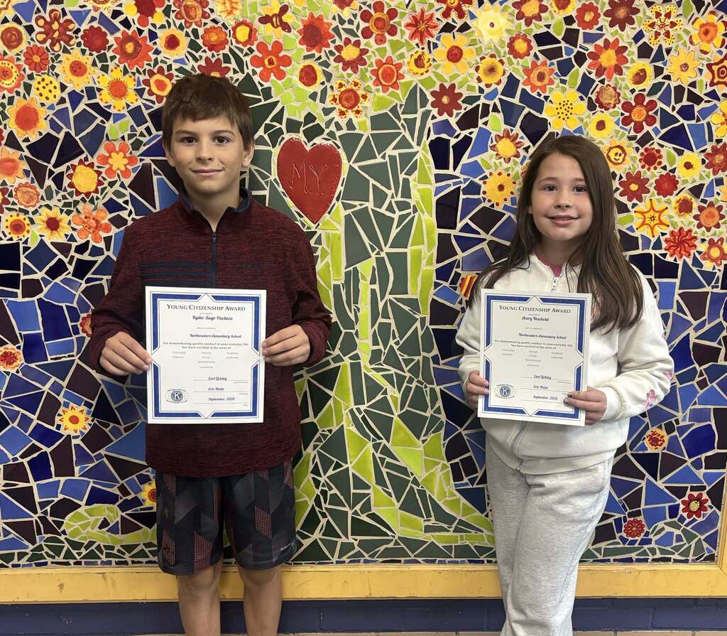 Kids pose while holding a certificate