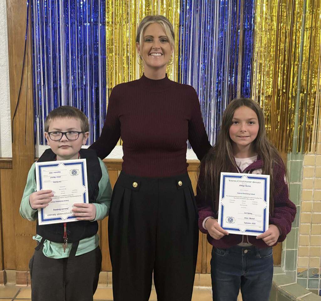 Kids pose while holding a certificate