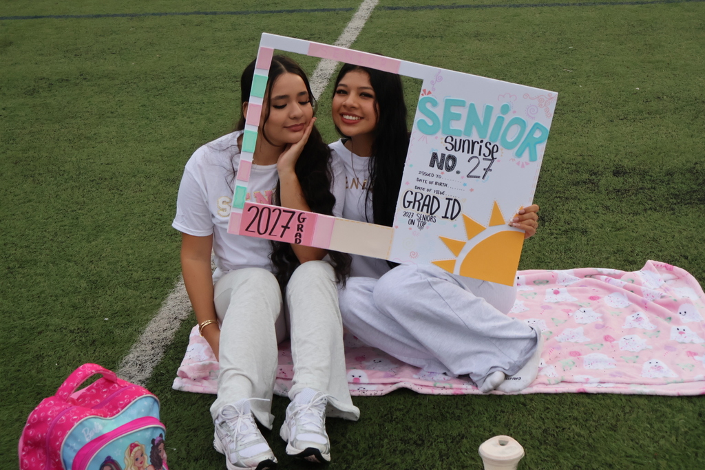 Students pose for photos with their Senior Sunrise cutouts