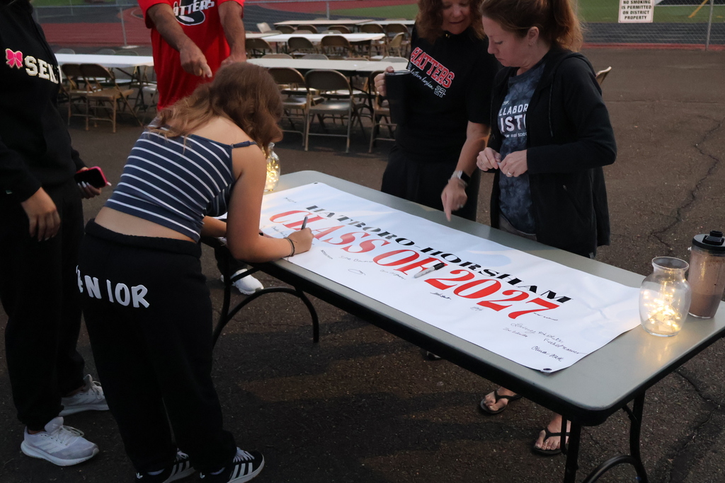 Students sign their Class of 2027 Banner