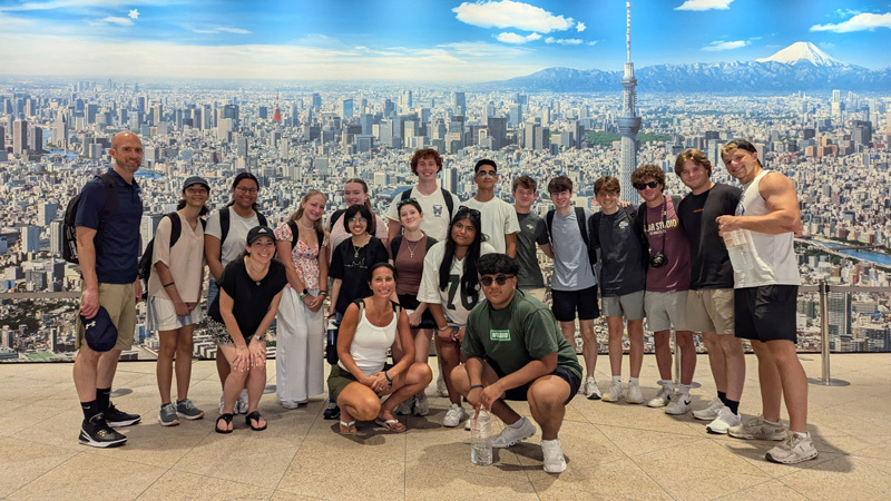 group photo in front of city