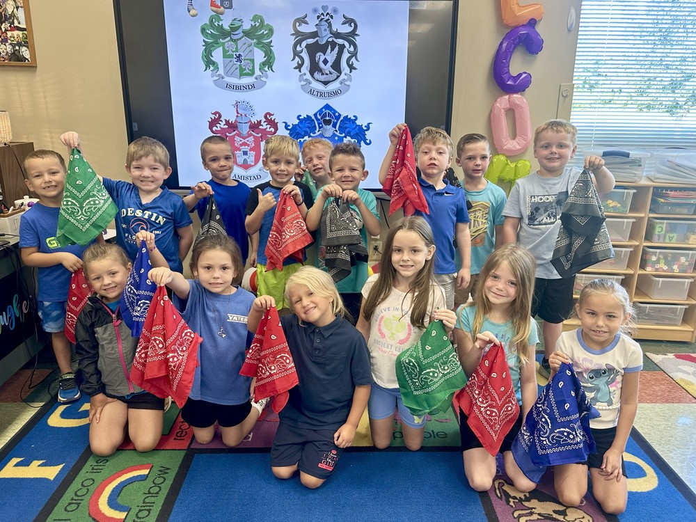 kindergarten students holding house color bandanas