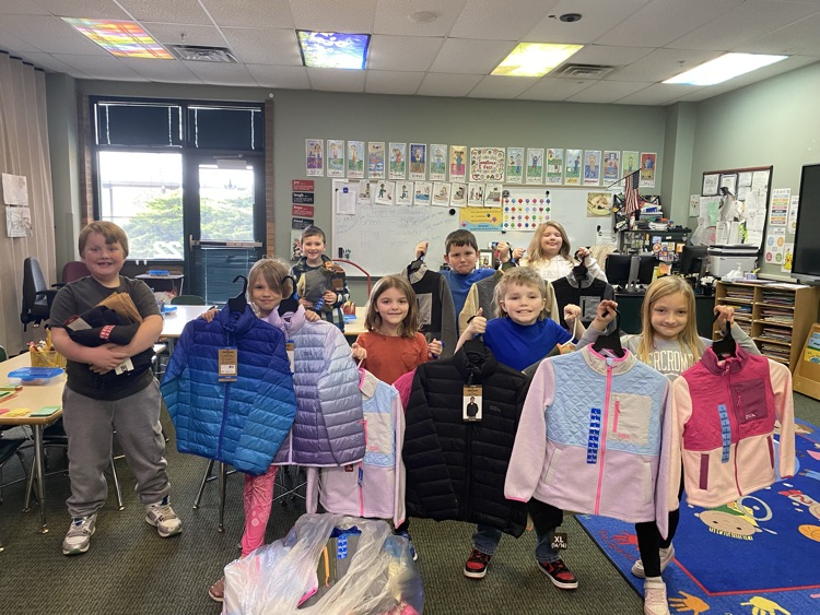 students holding coats