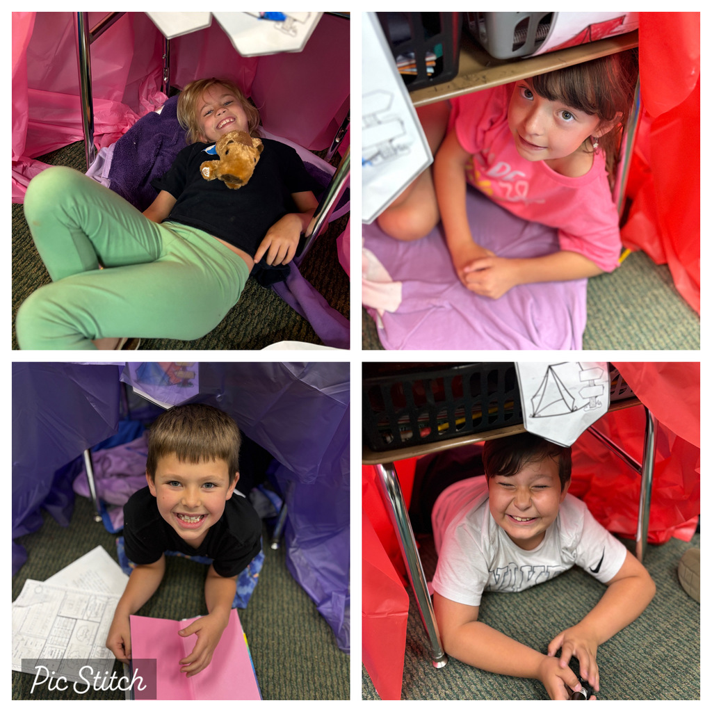 Four children in various positions in small tents or cubbies, some with books and one holding a stuffed animal.