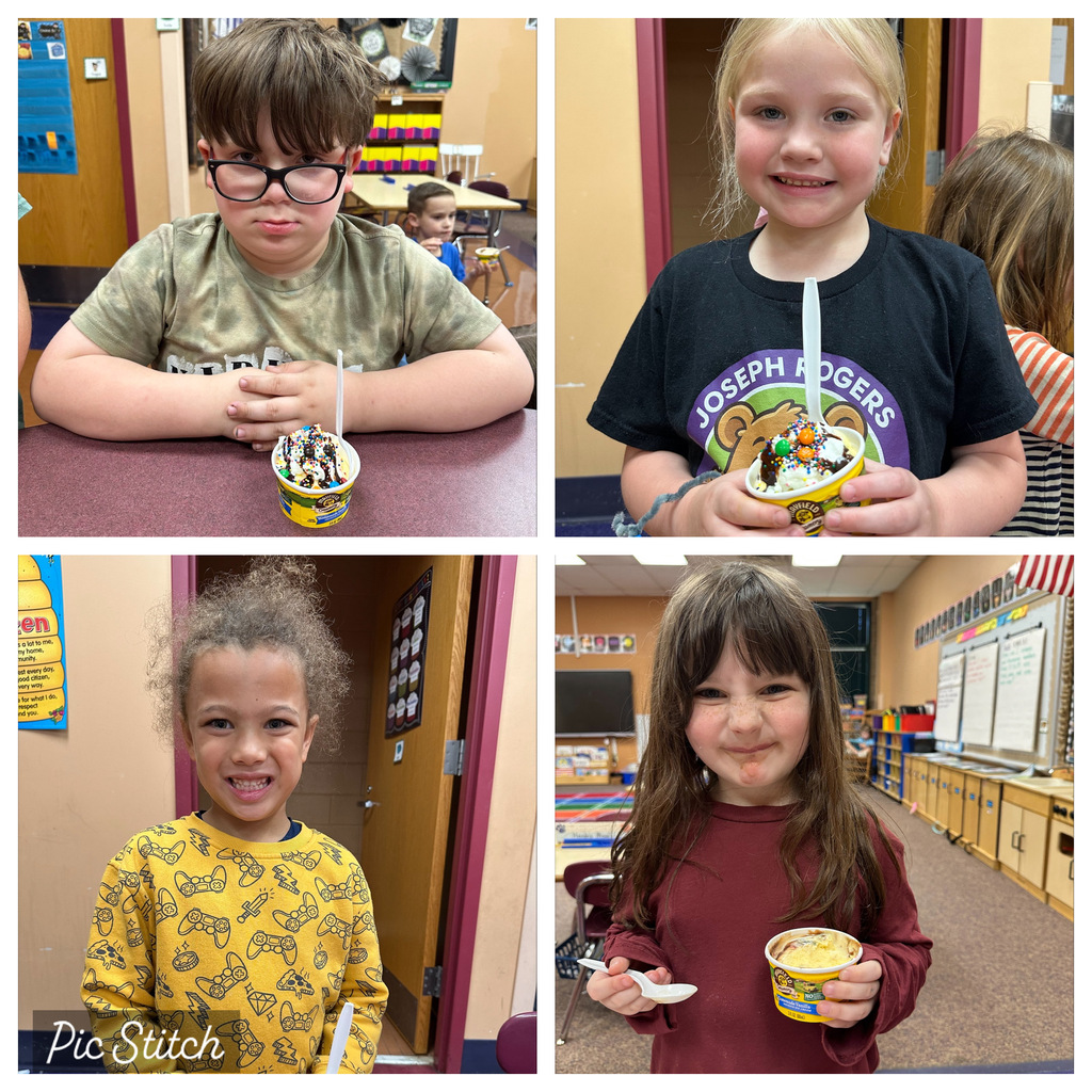 Four children, each in different clothing, eating ice cream in a classroom. A watermark is in the bottom left.