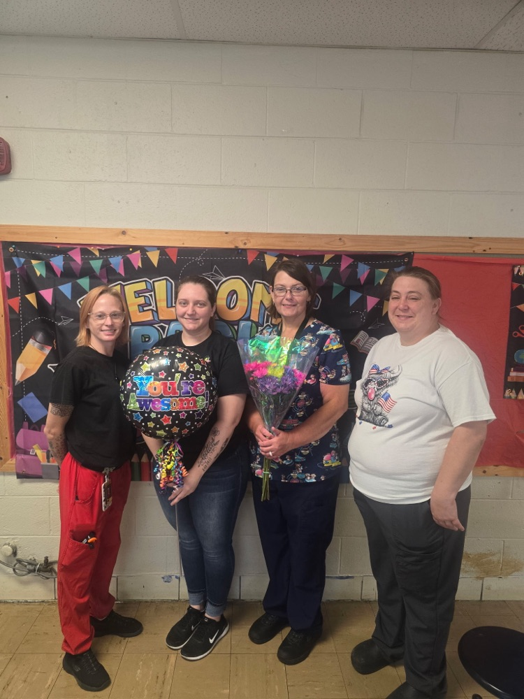 cafeteria staff with balloons and flowers 