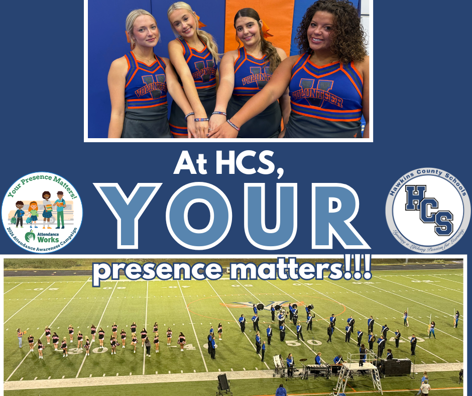 Four cheerleaders in blue uniforms, positioned together with a large group of people in a stadium in the background.