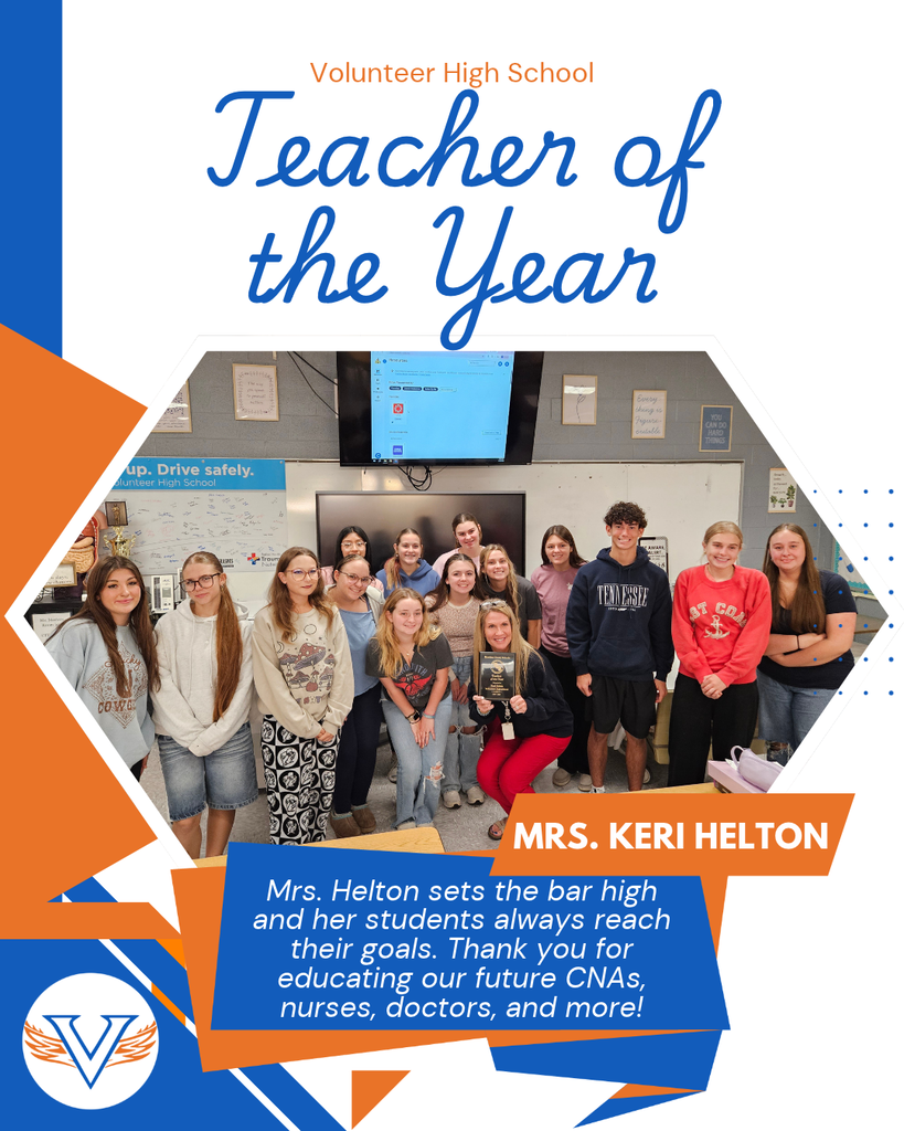 Group photo of students and teacher in a classroom with a mounted monitor; text above reads "Teacher of the Year" and below reads "Mrs. Keri Helton".