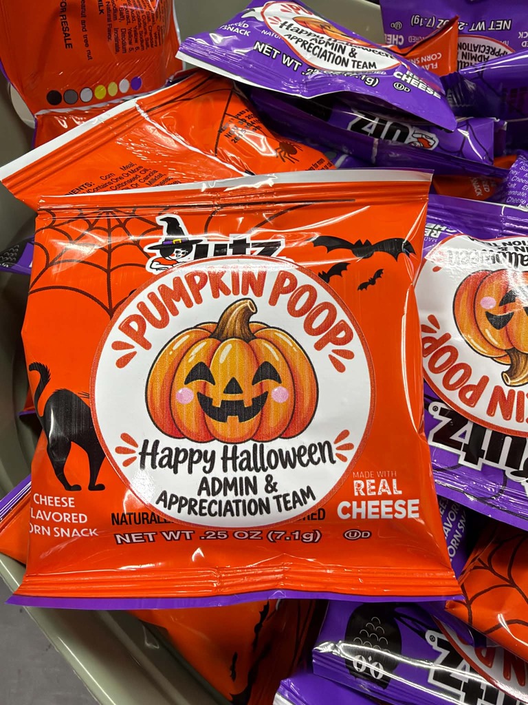 Stack of bags with Halloween themed designs, including pumpkin, spider web, and black cat.