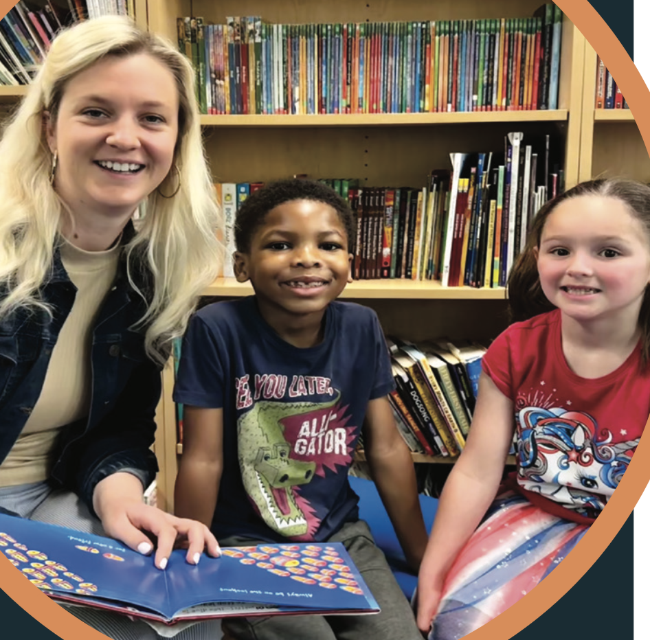 teacher reading with two students