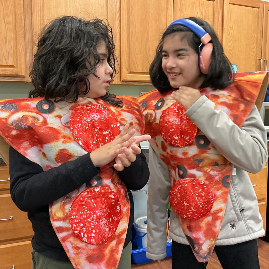 Students dressed as two slices of pizza for Halloween parade