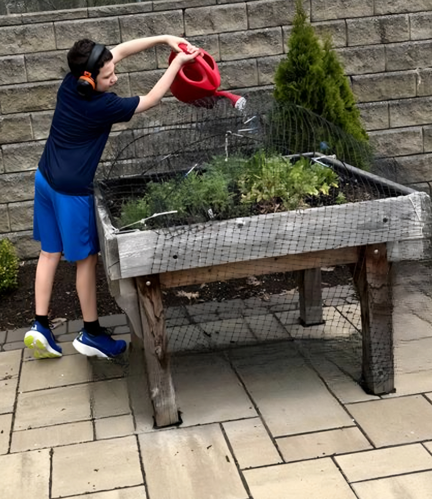Student watering the gard