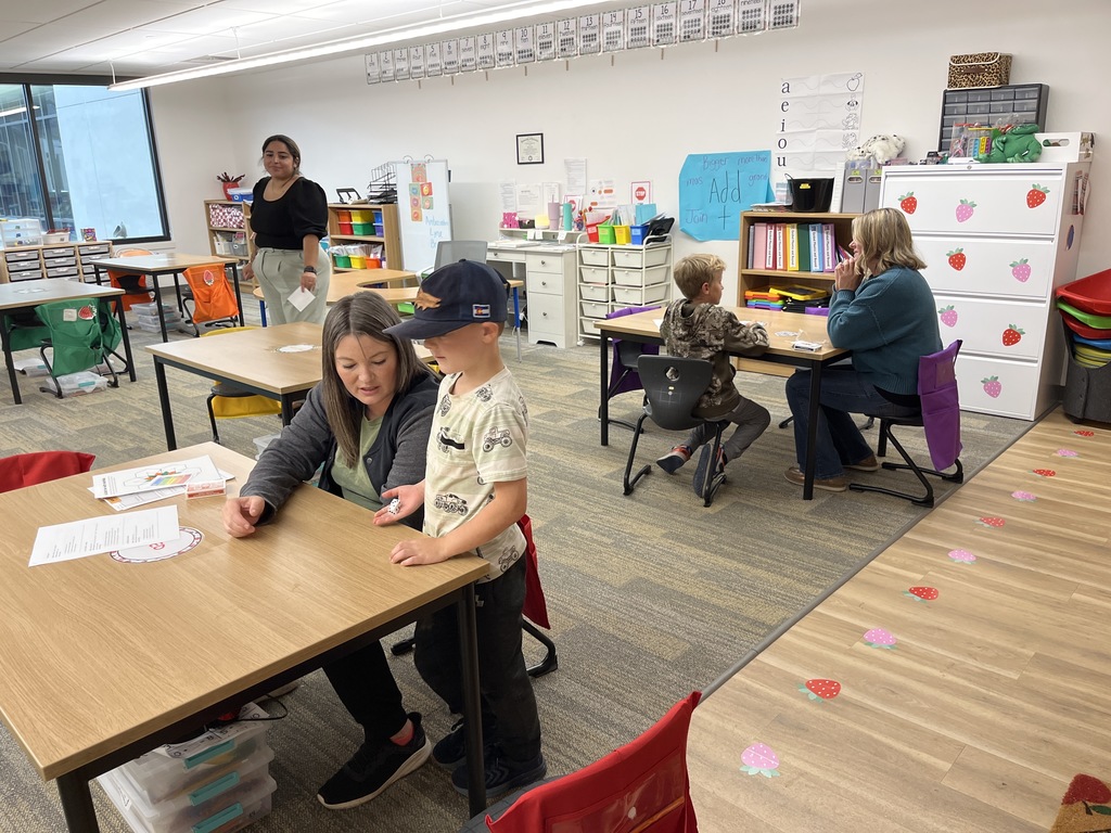 Parents with students doing an activity at tables