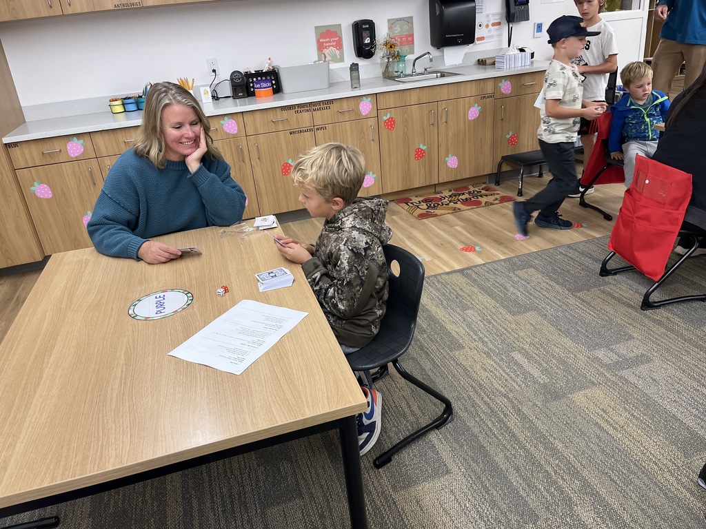 Parents with students doing an activity at tables