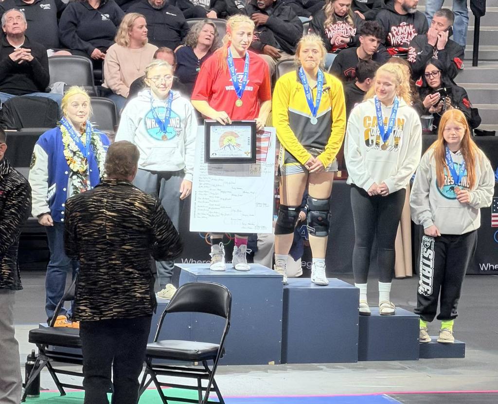 Emily Hockaday on podium State Wrestling for 6th Place