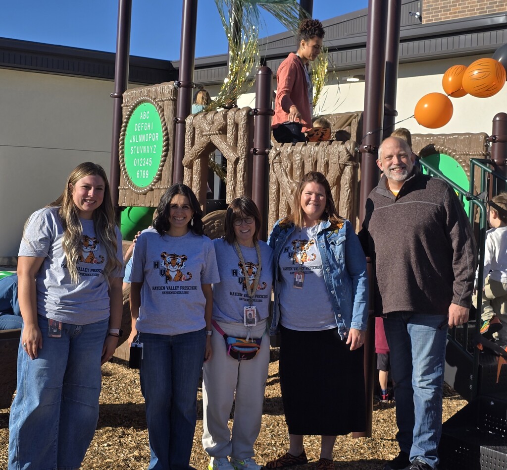 Administrative Staff and Preschool Teachers in front of preschool play structure