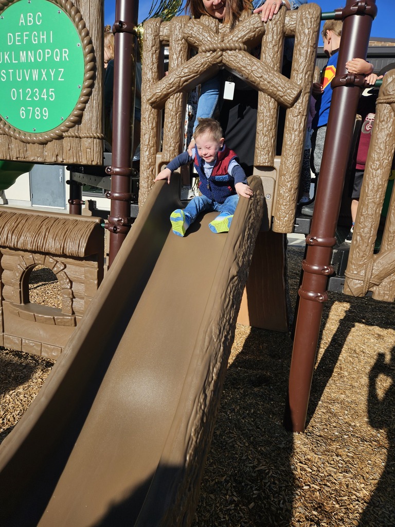Student going down the Preschool Slide
