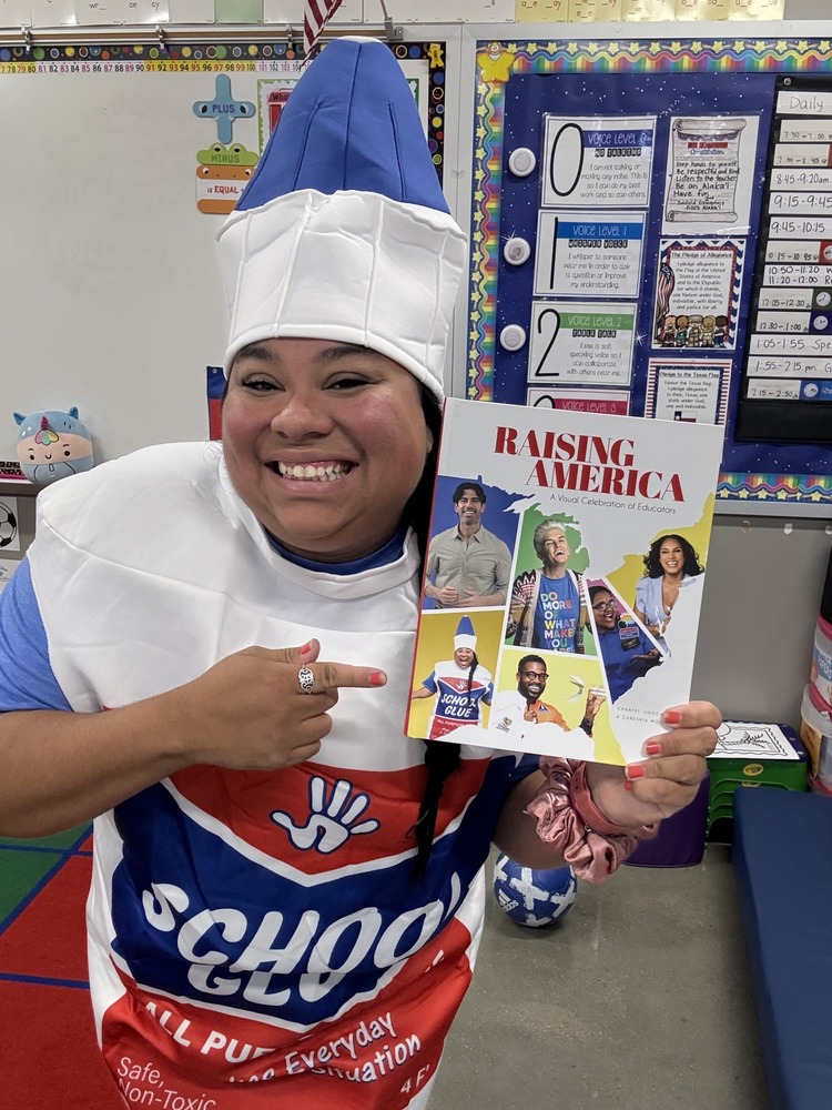 Keke Powell dressed as glue alongside a book