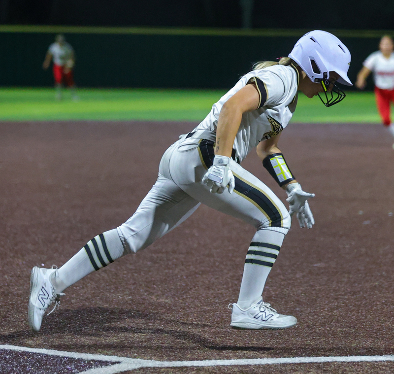 A softball player for Johnson high school running on the field.