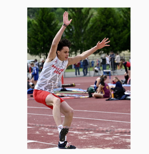 newspaper article photo of hazleton triple jumper Lucas in action