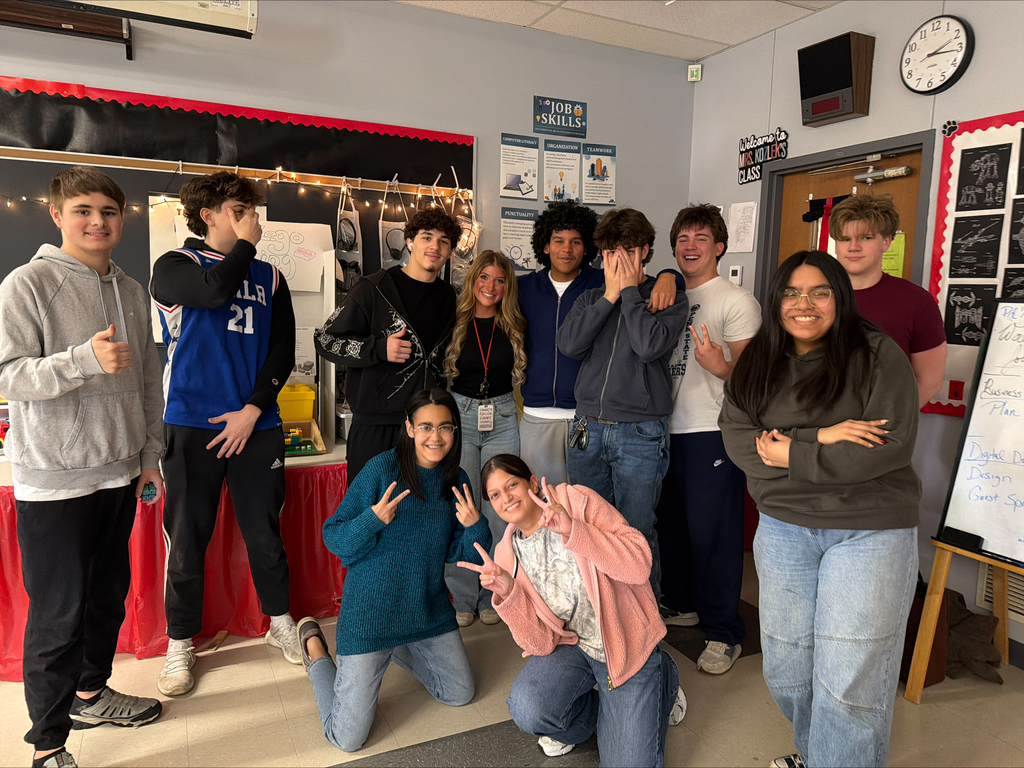 group of students and district webmaster posing for a picture