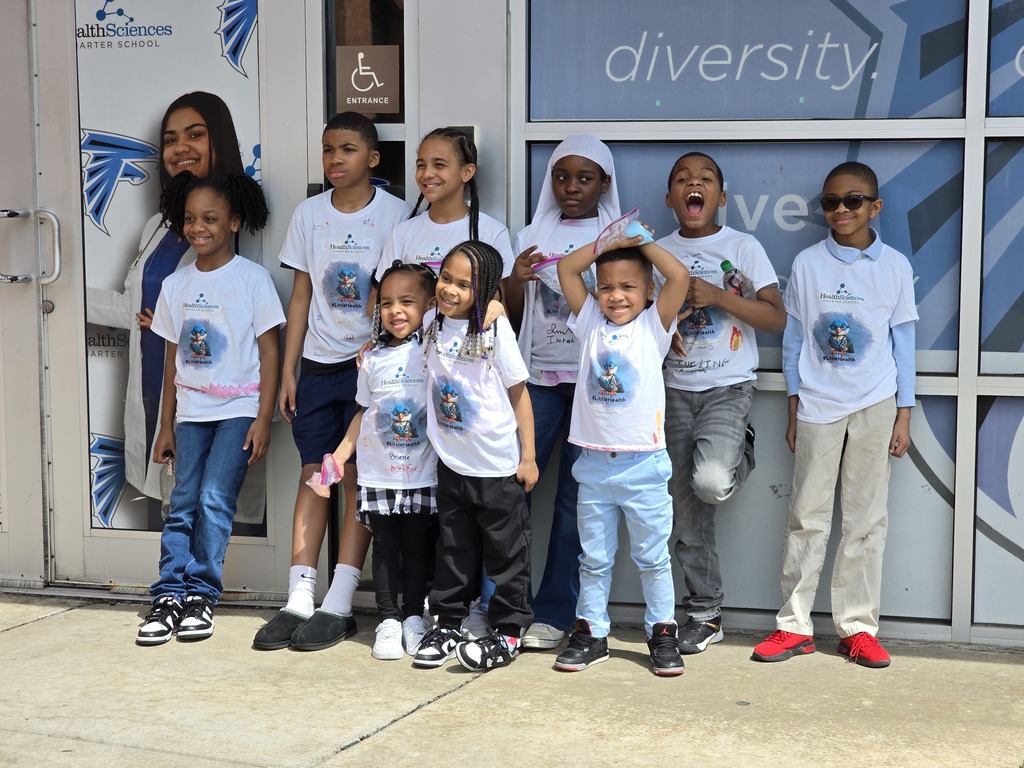 Kids posing in front of Health Sciences Charter School on Take Your Child to Work Day